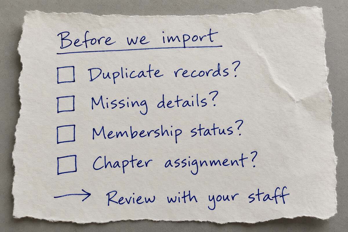 Handwritten checklist on scrap paper: duplicate records, missing details, membership status and chapter assignment, followed by review with your staff